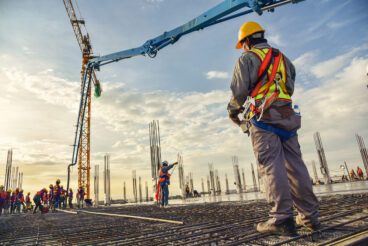 A,Construction,Worker,Control,A,Pouring,Concrete,Pump,On,Construction